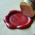 Red wax seal stamped on a paper envelope
